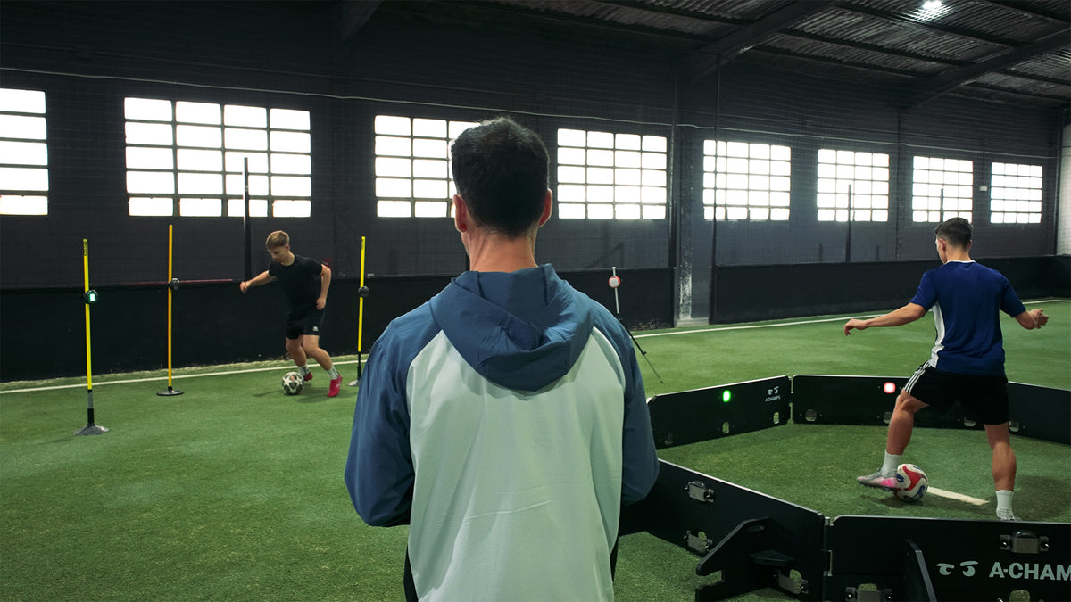 Coach observing players in a Goal Station environment