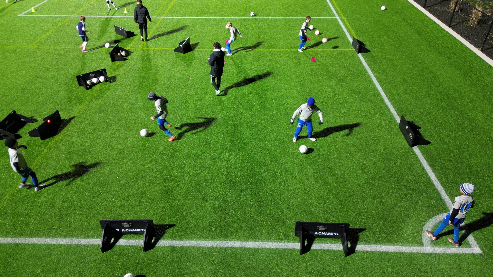 Soccer practice session on a field with Goal Station rebounders.